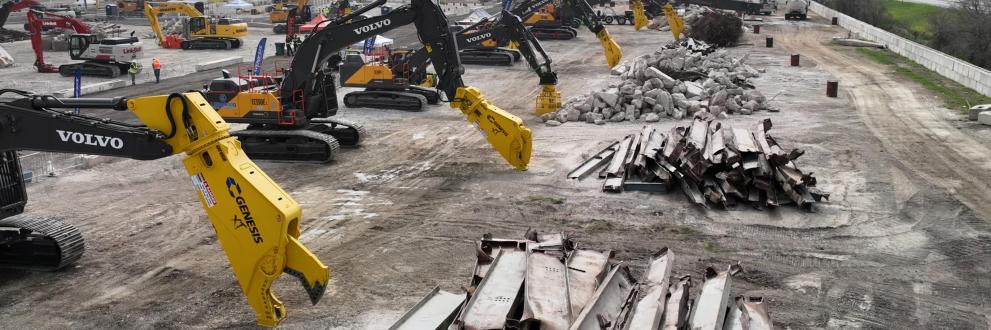 A line of yellow Genesis attachments on Volvo excavators