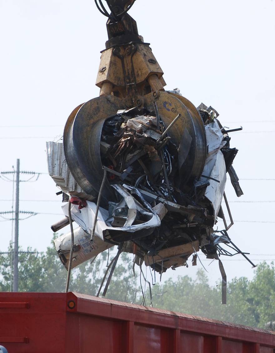 Yellow grapple full of scrap